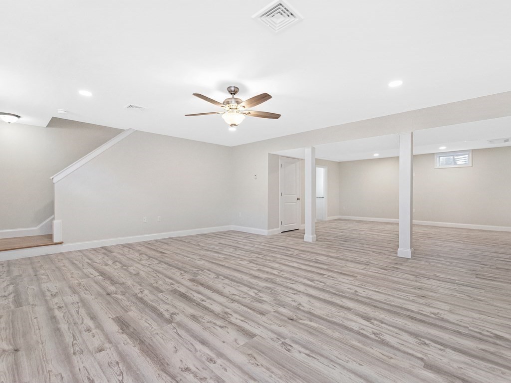 125 Thornton Road Waltham, MA 02453 - Photo 35 of 42 an empty room with wooden floor and a ceiling fan