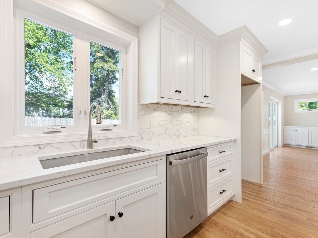 125 Thornton Road Waltham, MA 02453 - Photo 8 of 42 a kitchen with granite countertop white cabinets and a window