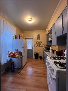 a kitchen with wooden cabinets and a stove top oven