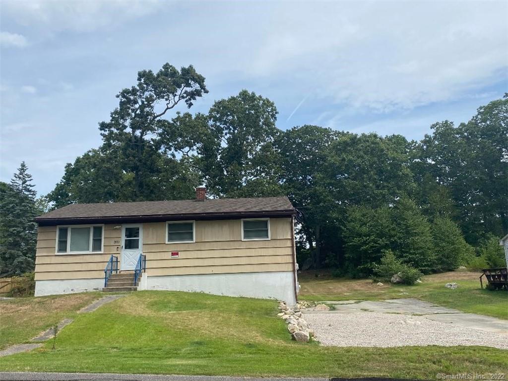 166 Flanders Road Stonington, CT 06378 - Photo 1 of 1 a front view of a house with a yard