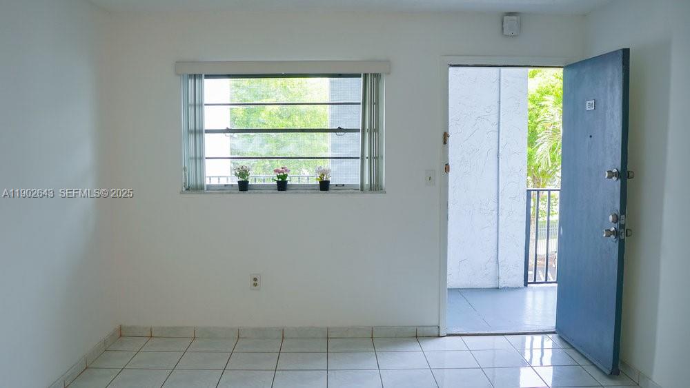 2496 Southwest 17th Avenue, Unit 5308 Miami, FL 33145 - Photo 4 of 19 a view of an empty room with a window