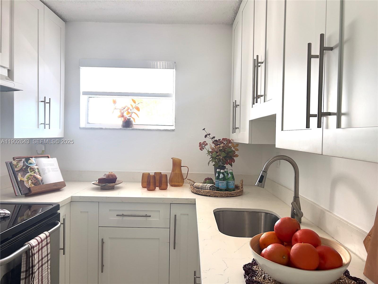 2496 Southwest 17th Avenue, Unit 5308 Miami, FL 33145 - Photo 6 of 19 a kitchen with a sink cabinets and window