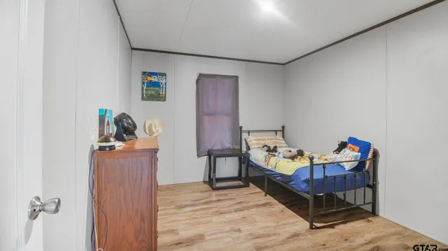 a bedroom with furniture and a wooden floor