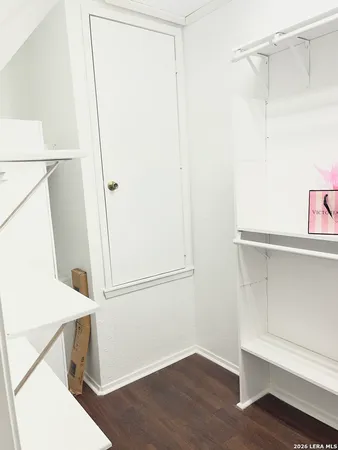 a view of walk in closet with empty racks