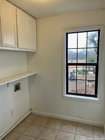a view of kitchen with window and cabinets