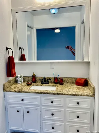 a bathroom with a sink and a mirror