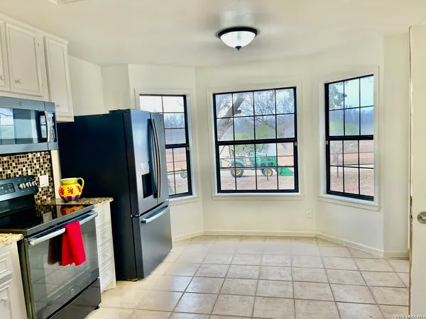 a kitchen with refrigerator and window