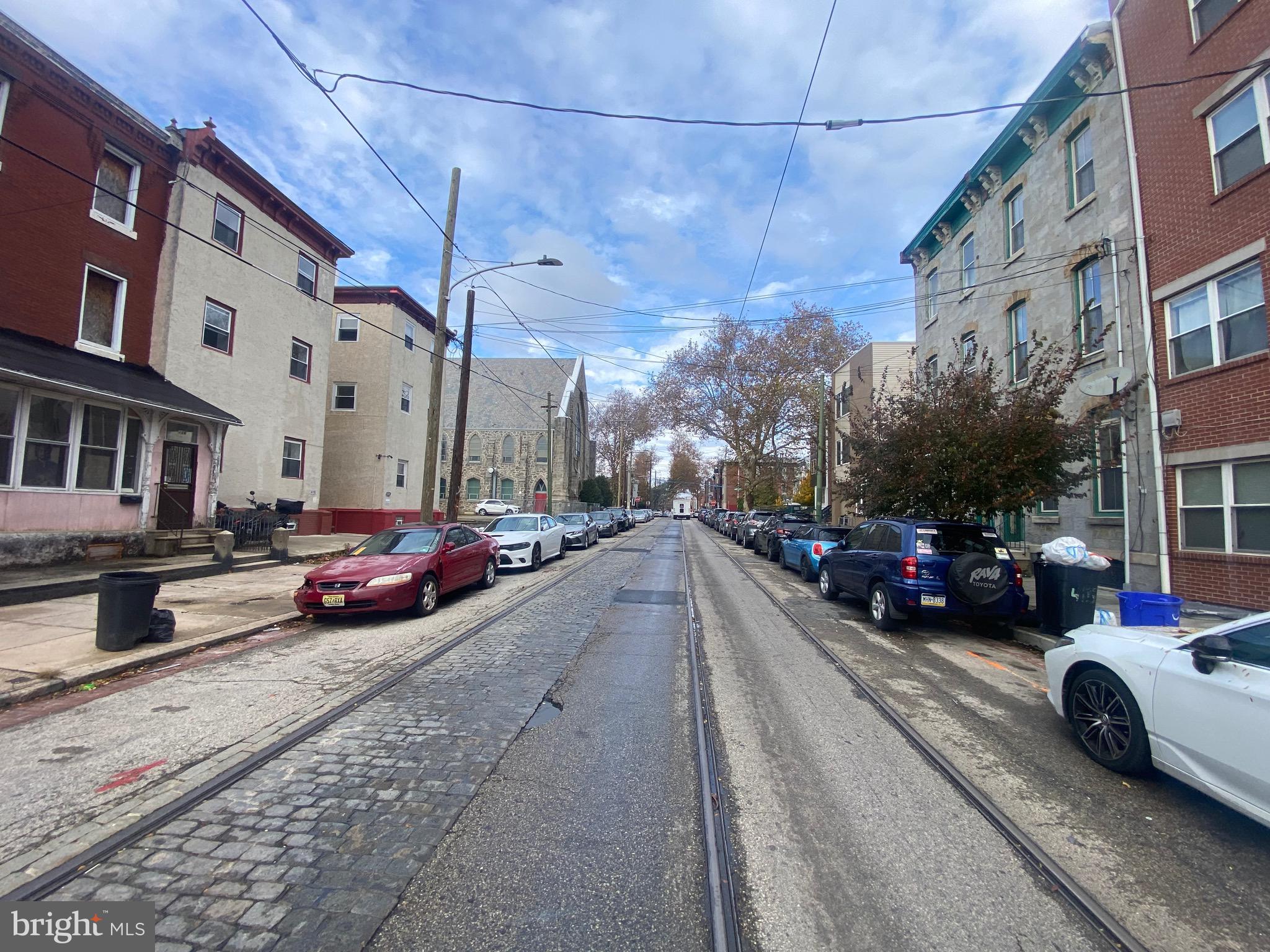 413 North 41st Street, Unit A Philadelphia, PA 19104 - Photo 4 of 4 a view of a street with cars and a cars parked on the road