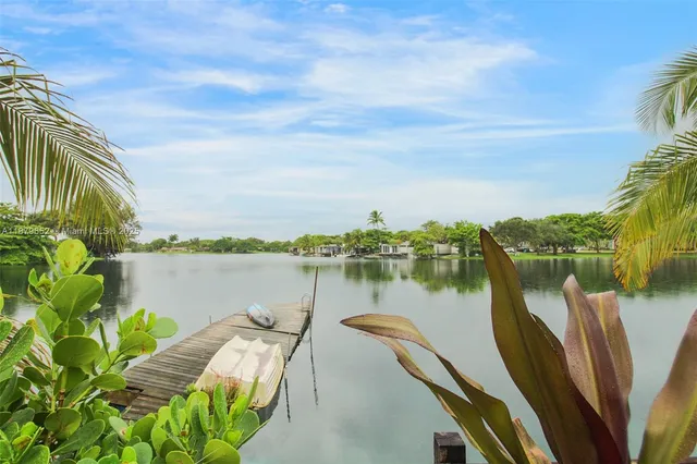 a view of a lake with couches in the patio