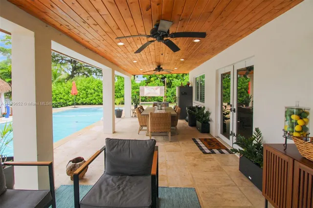 a living room with furniture tv and a large window