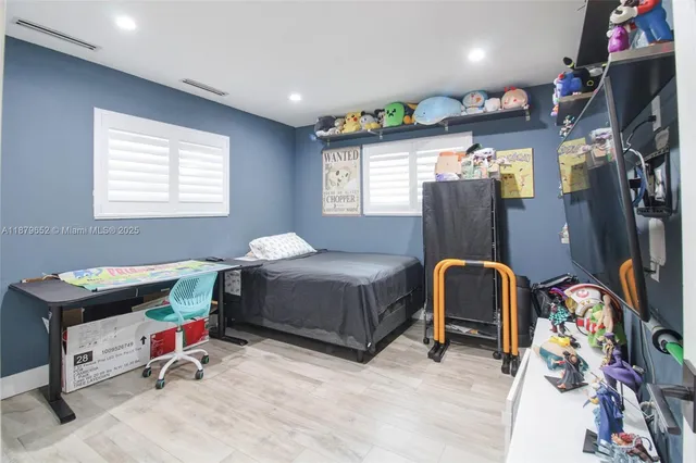 a bedroom with bed and a window