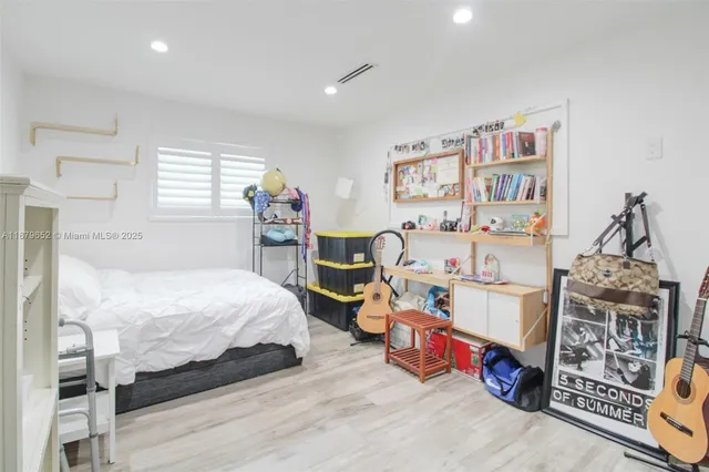 a bedroom with bed and a window