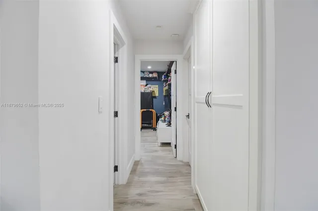 a view of a hallway with wooden shelves