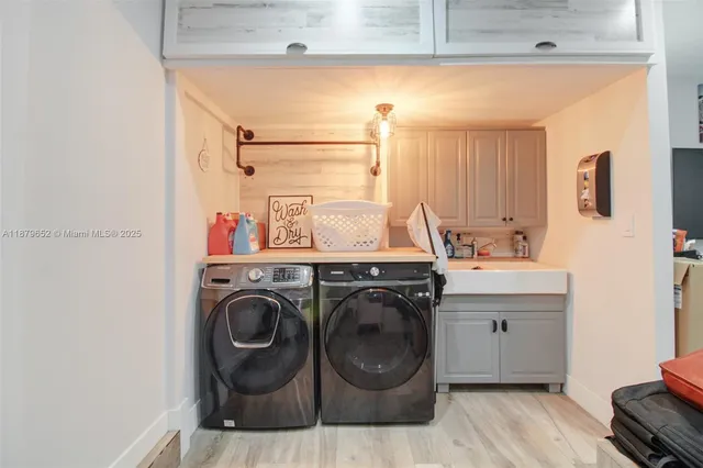 a utility room with sink dryer and washer