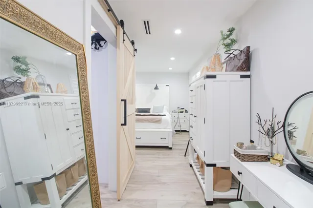 a view of a hallway to a livingroom and furniture