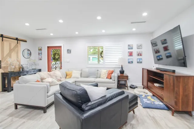 a bedroom with furniture and a flat screen tv
