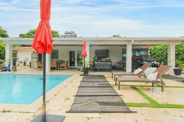 a view of a swimming pool with a patio