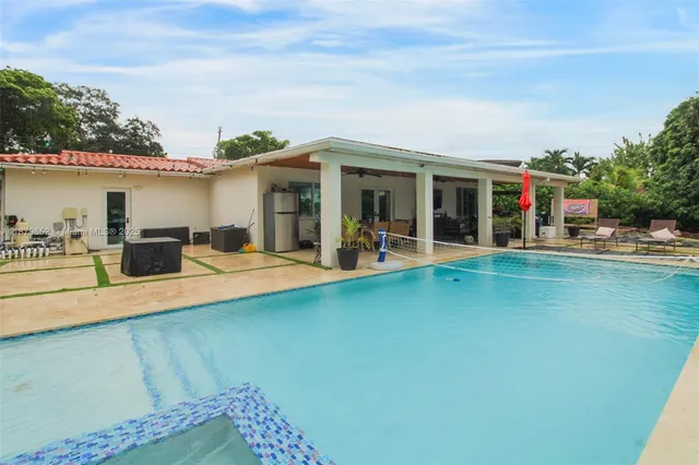a view of a swimming pool with furniture