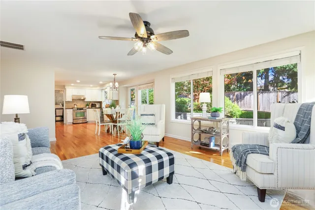 a living room with patio furniture and a large window