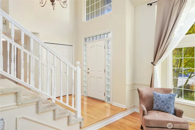 a living room with furniture and a floor to ceiling window