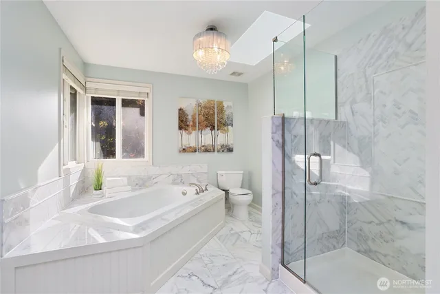 a bath room with a bath tub and shower