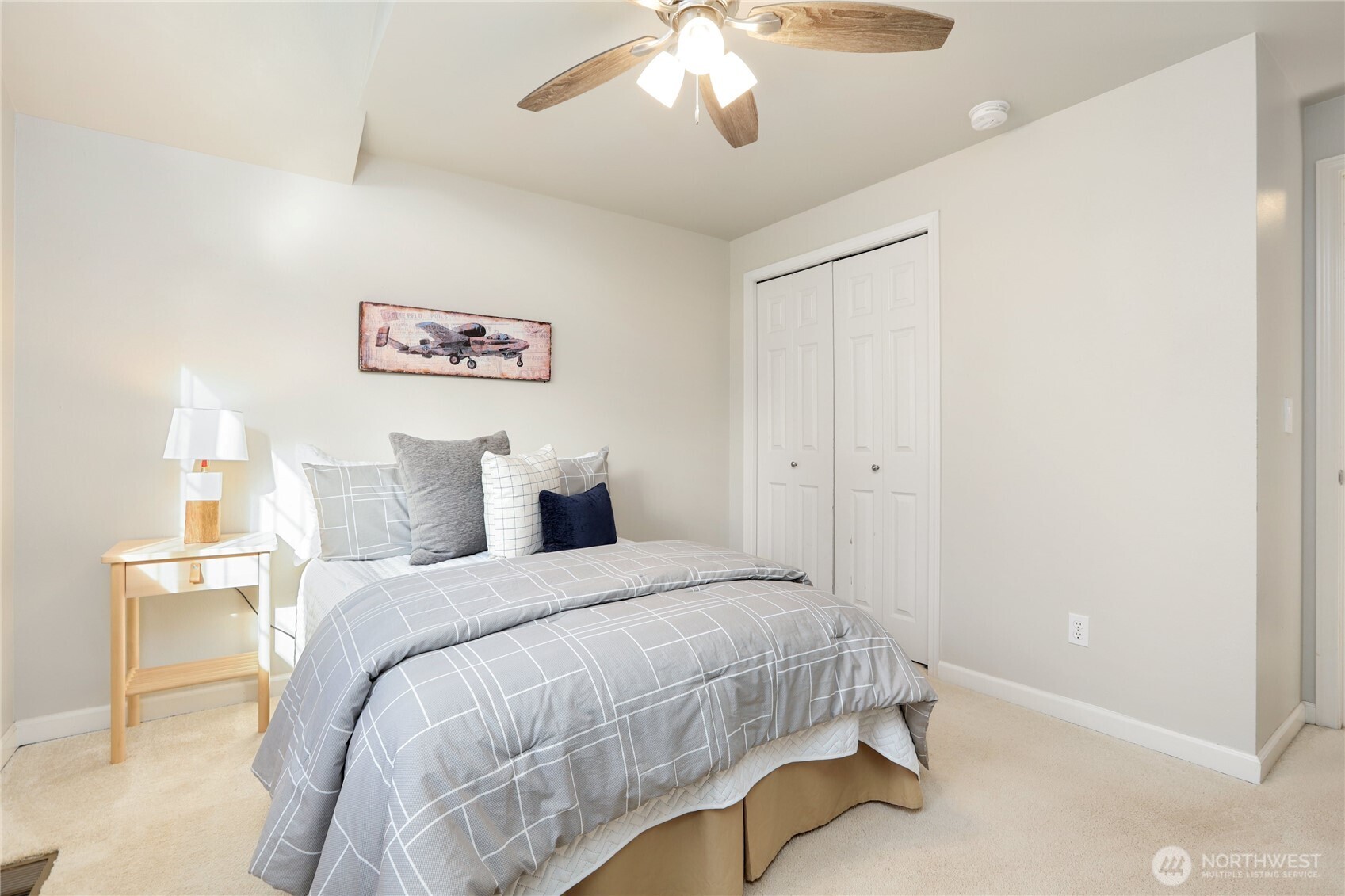 6405 154th Street Southeast Snohomish, WA 98296 - Photo 27 of 39 a bedroom with a bed and a chandelier