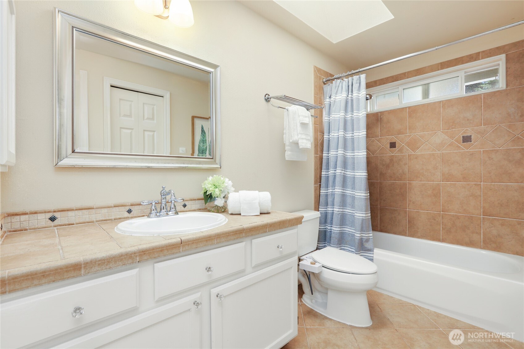 6405 154th Street Southeast Snohomish, WA 98296 - Photo 28 of 39 a bathroom with a granite countertop sink toilet a mirror and shower
