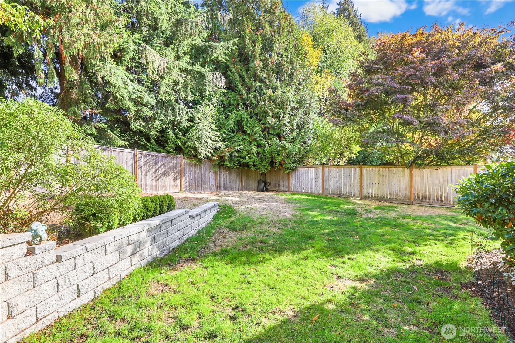 6405 154th Street Southeast Snohomish, WA 98296 - Photo 33 of 39 a view of a backyard with large tree and wooden fence