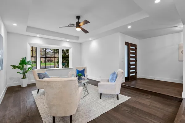 a living room with furniture and a potted plant