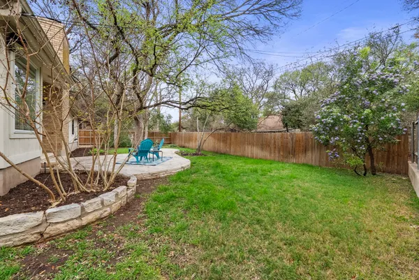 a view of a backyard with plants and a slide