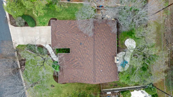 a aerial view of a house with large trees and plants