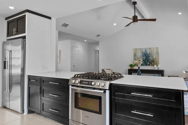 a kitchen with a stove and a refrigerator