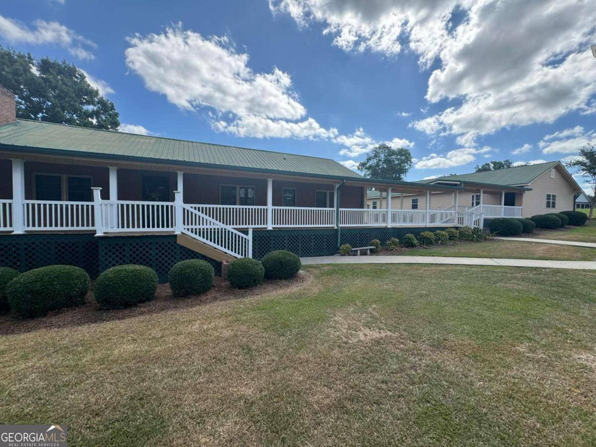 207 Bill Branch Road Baxley, GA 31513 - Photo 1 of 1 a view of a house with a backyard and a large tree
