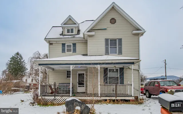 a front view of a house with parking space