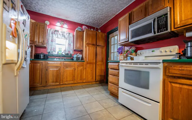 a kitchen with stainless steel appliances granite countertop a stove and a refrigerator