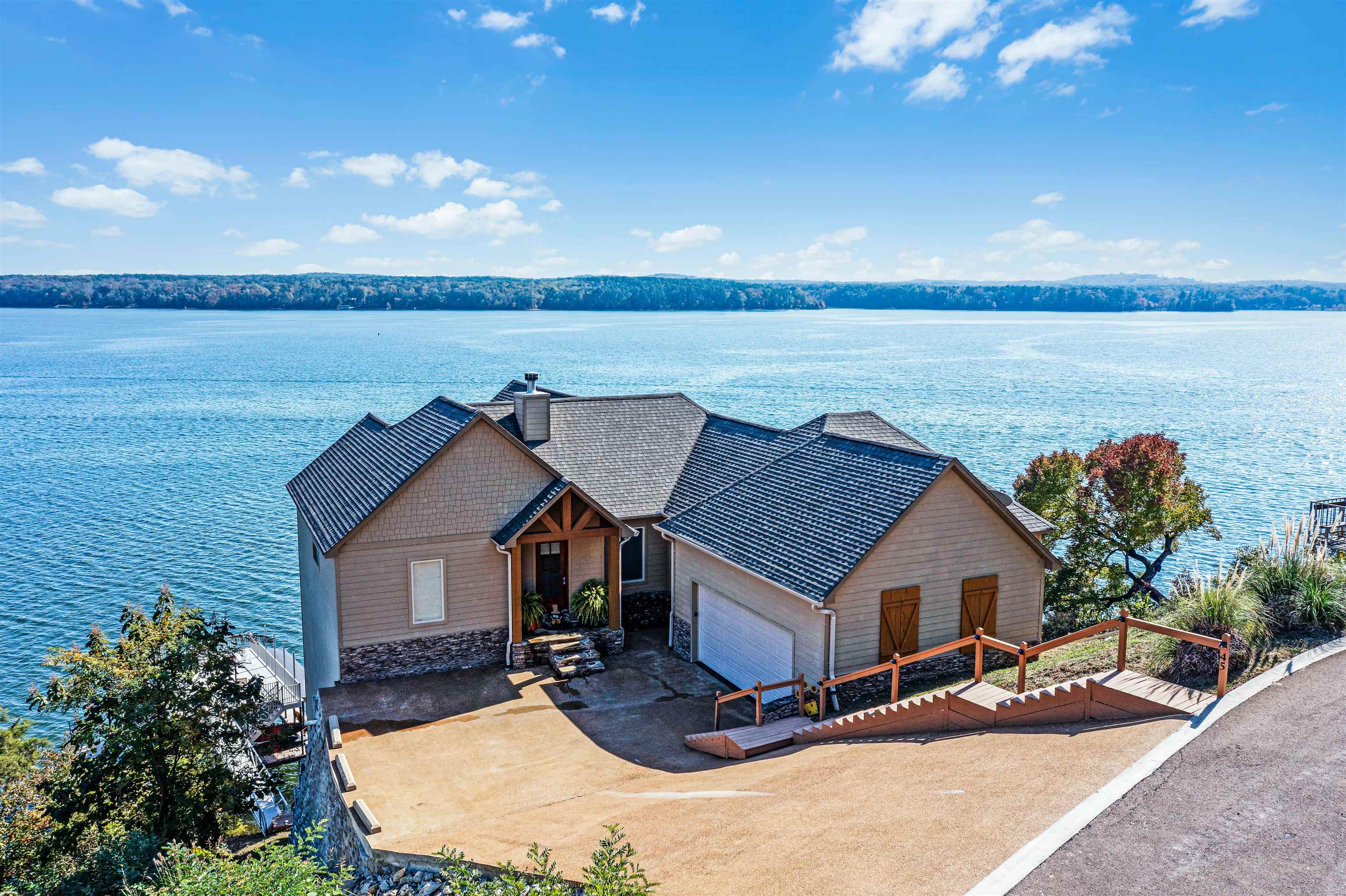 a view of a house with yard and ocean view
