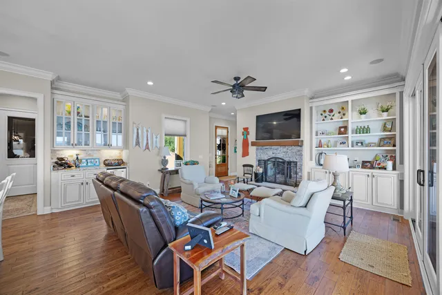 a living room with fireplace furniture and a wooden floor
