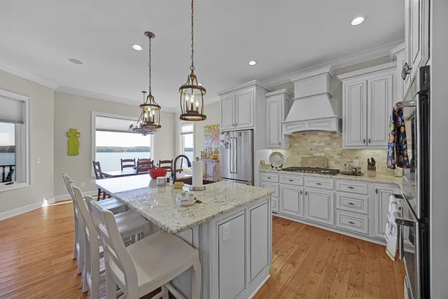 a kitchen with stainless steel appliances granite countertop a sink stove and refrigerator