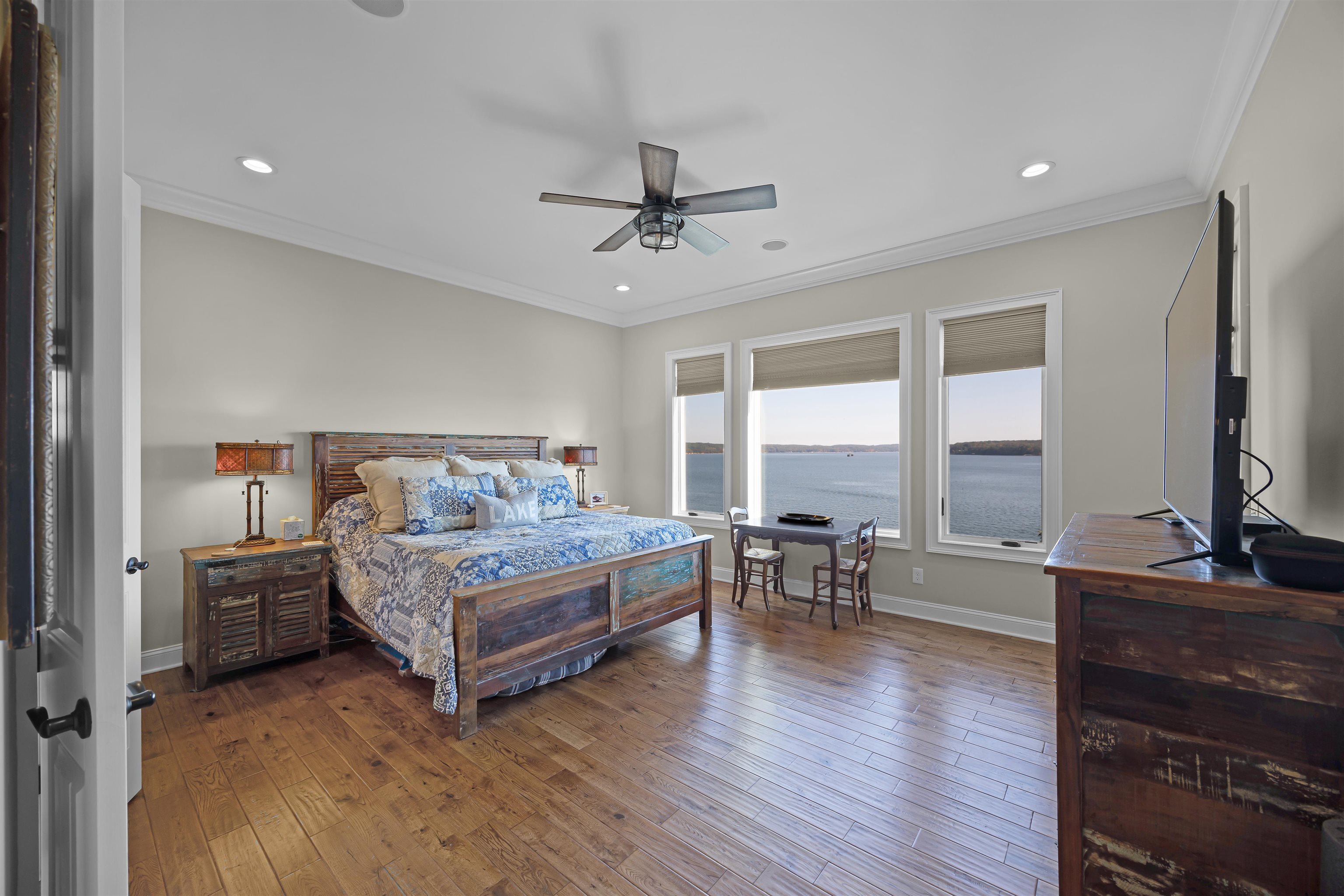 45 Pinnacle Pointe Savannah, TN 38372 - Photo 18 of 30 a bedroom with a bed large window and a flat tv screen