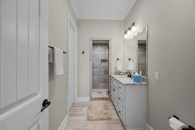 a bathroom with a double vanity sink a mirror and a shower