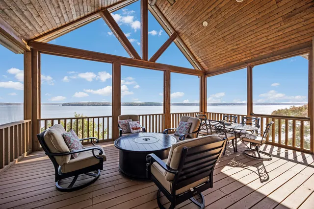 a balcony with wooden floor outdoor seating and city view