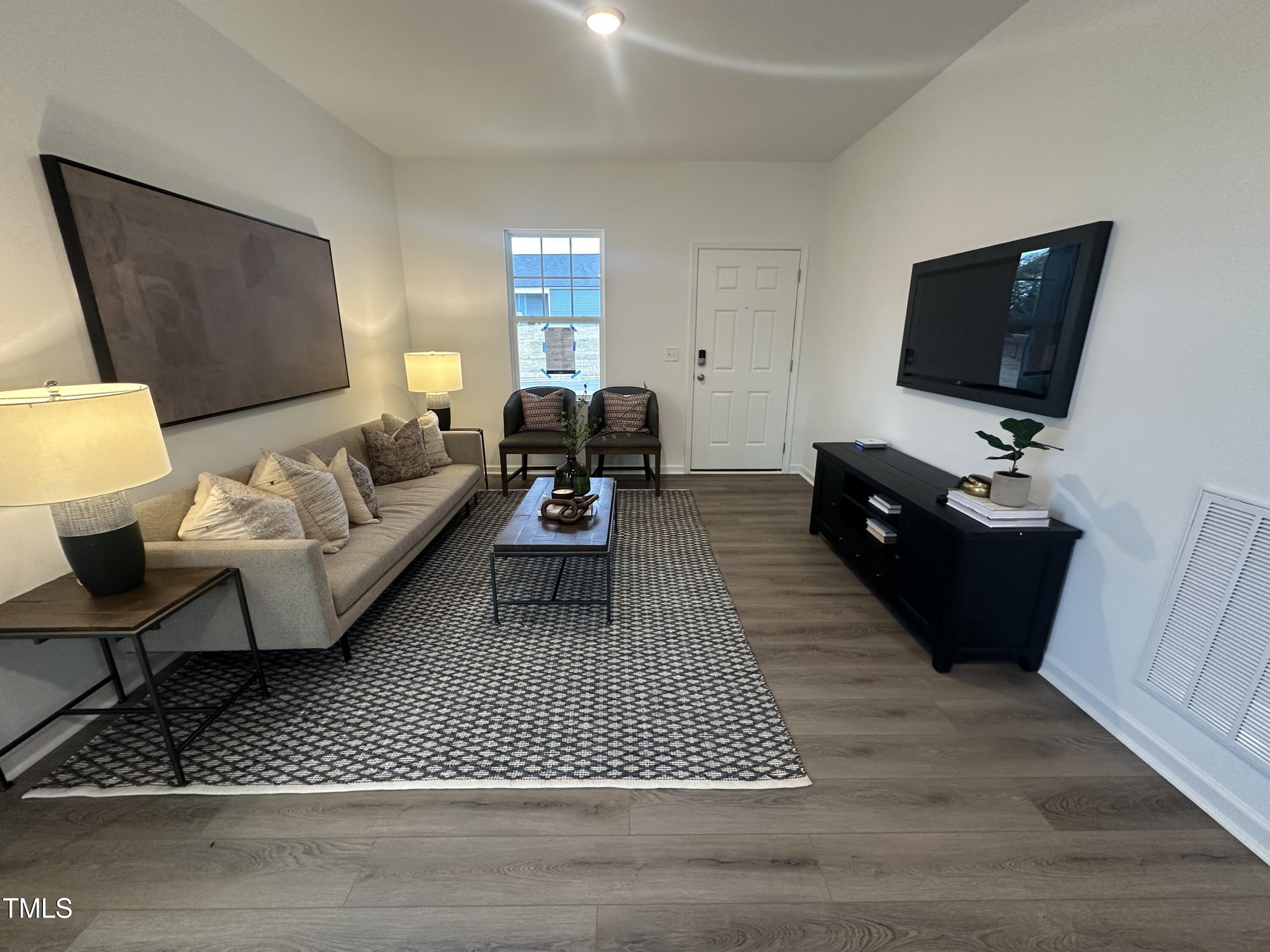 11198 Salers Loop Middlesex, NC 27557 - Photo 16 of 34 a living room with furniture a flat screen tv and a couch