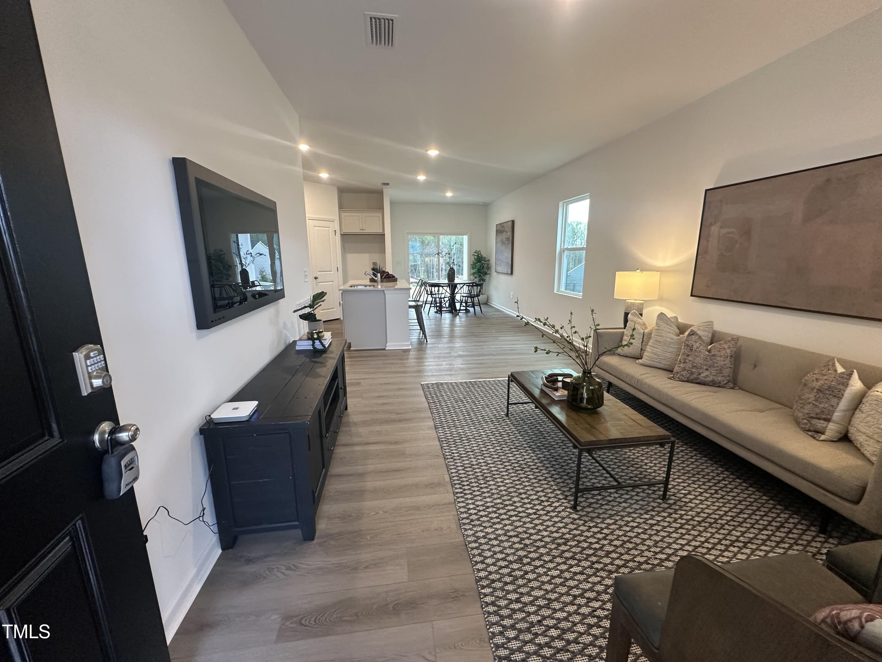 11198 Salers Loop Middlesex, NC 27557 - Photo 17 of 34 a living room with couches and a flat screen tv