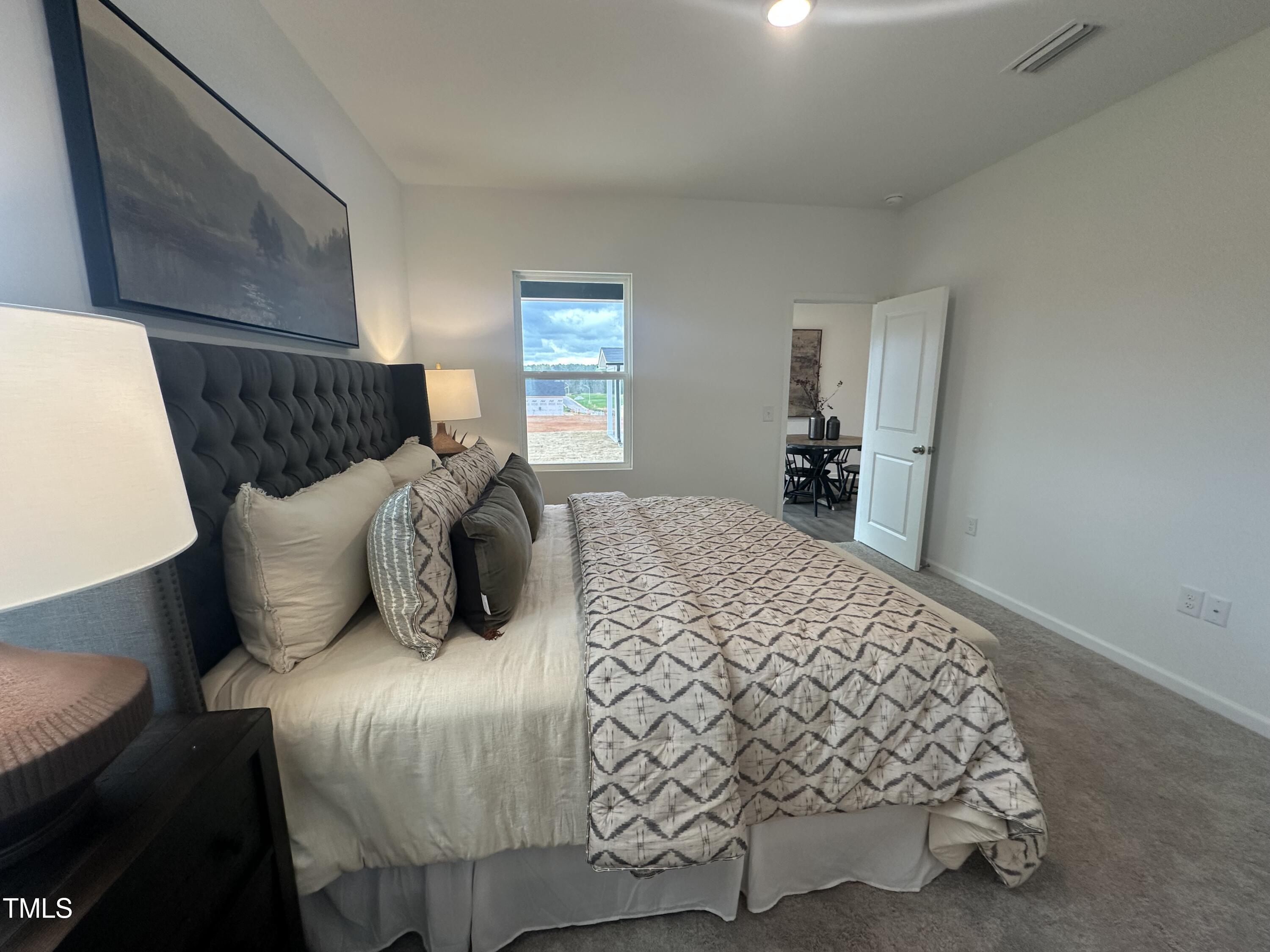 11198 Salers Loop Middlesex, NC 27557 - Photo 20 of 34 a bedroom with a bed and window