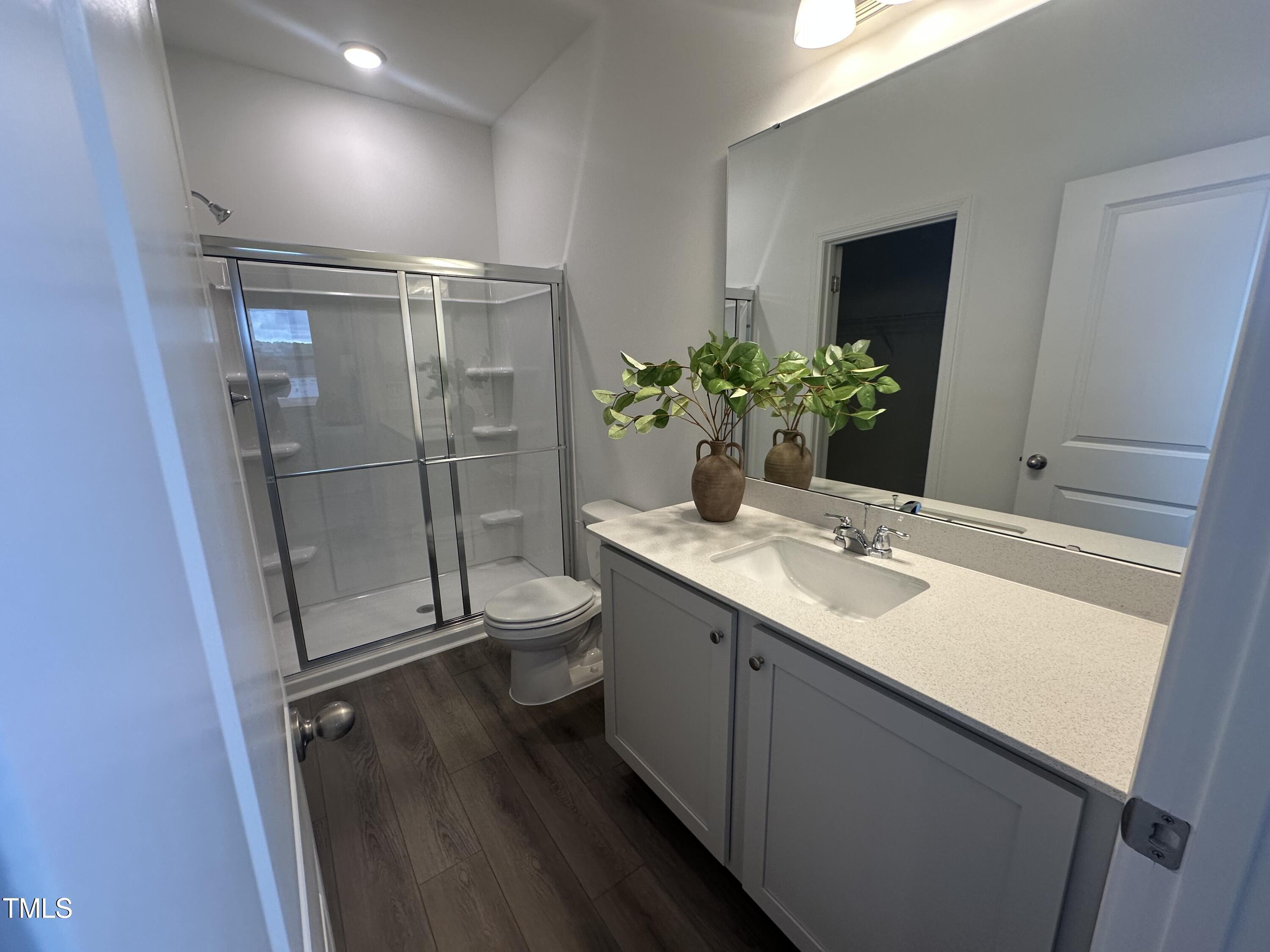 11198 Salers Loop Middlesex, NC 27557 - Photo 21 of 34 a bathroom with a granite countertop sink toilet and shower