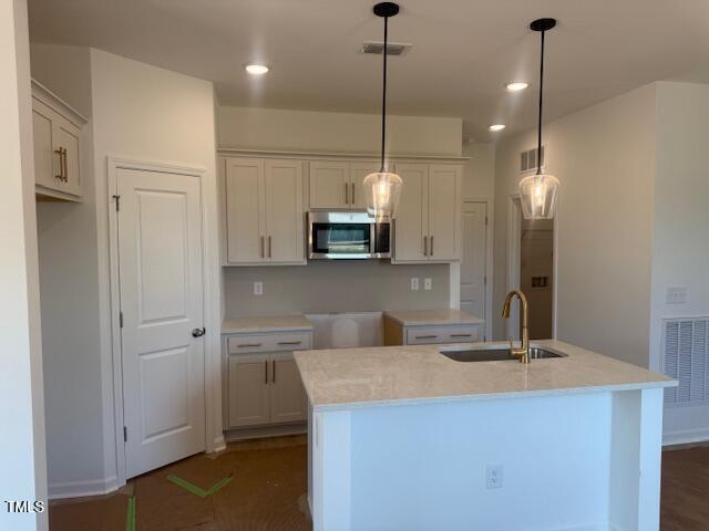 11198 Salers Loop Middlesex, NC 27557 - Photo 4 of 34 a kitchen with kitchen island a sink stainless steel appliances and cabinets