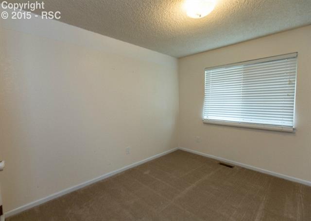 6620 Turkey Tracks Road Colorado Springs, CO 80922 - Photo 20 of 36 Bedroom #3 is quite large and carpeted