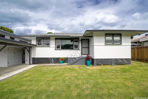 a view of a house with pool and a yard