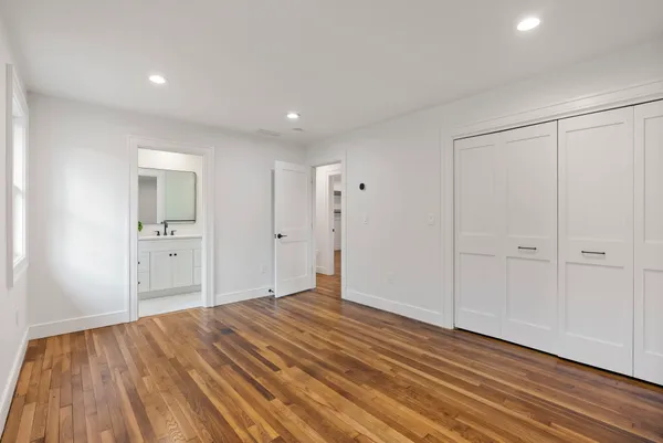 a view of a room with wooden floor and bathroom