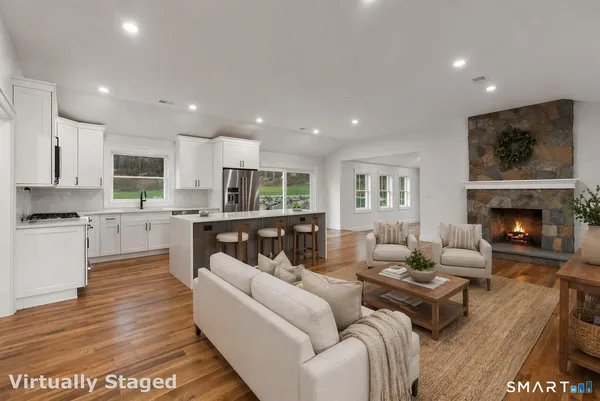 a living room with furniture and a fireplace